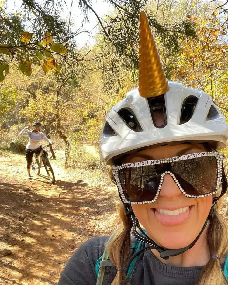 Helmet Flair MagNeatOhz unicorn modeled by a woman on a bike