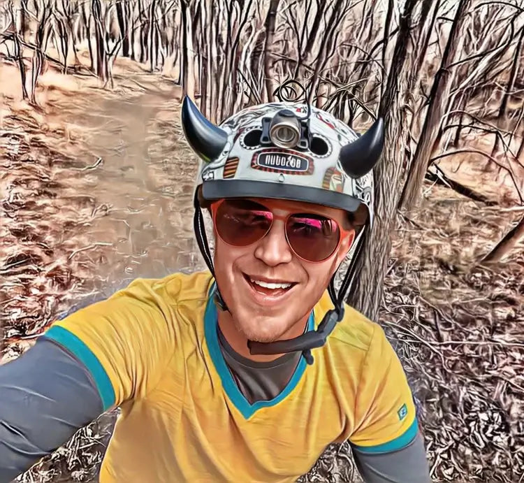 helmet flair devil horns modeled on a silver helmet worn by a bicyclist
