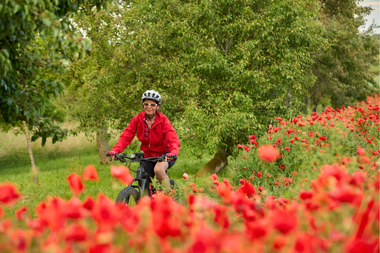 Active Senior enjoying riding an electric bicycle in a botanical garden