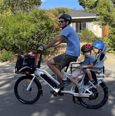 Family Ebike Collection image depicting a father riding his Eunorau Max-Cargo Ebike with two children on the back