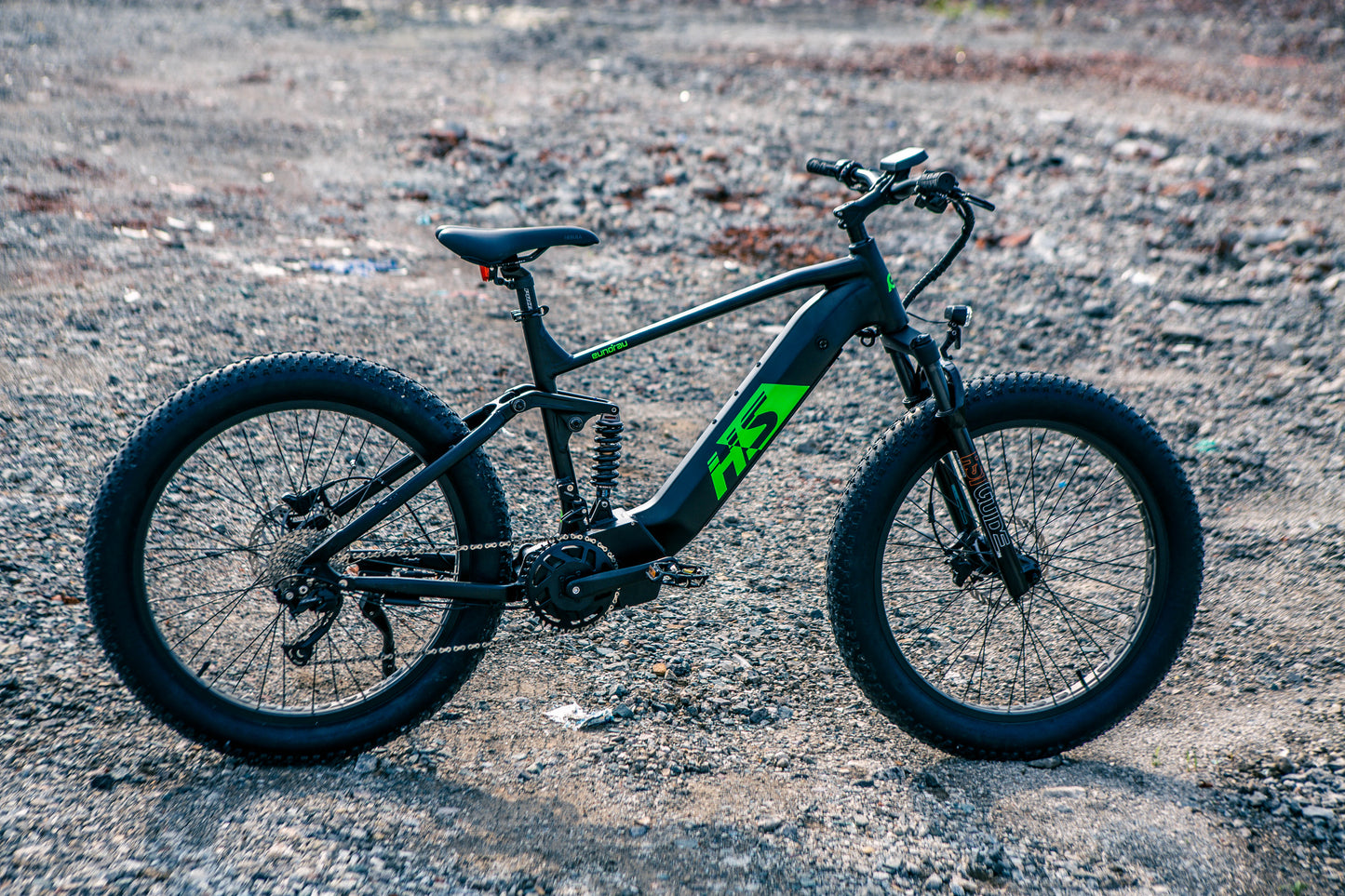 EUNORAU FAT-HS fat tire Ebike with dual suspension and powerful mid-drive motor on rugged trail, ideal for outdoor adventurers.