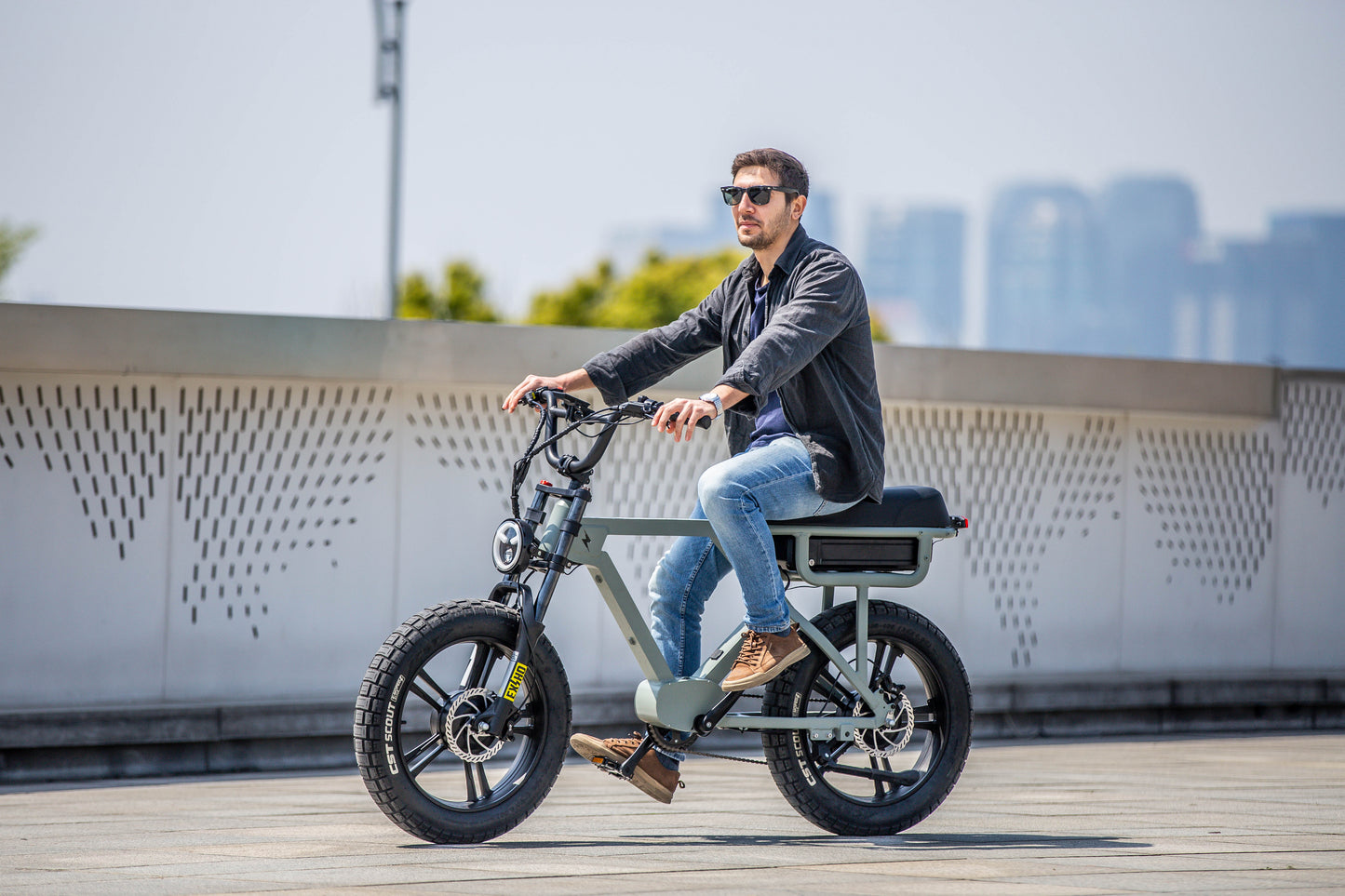 EUNORAU FLASH stylish ebike available in mid drive rear hub drive and all wheel drive with cityscape background