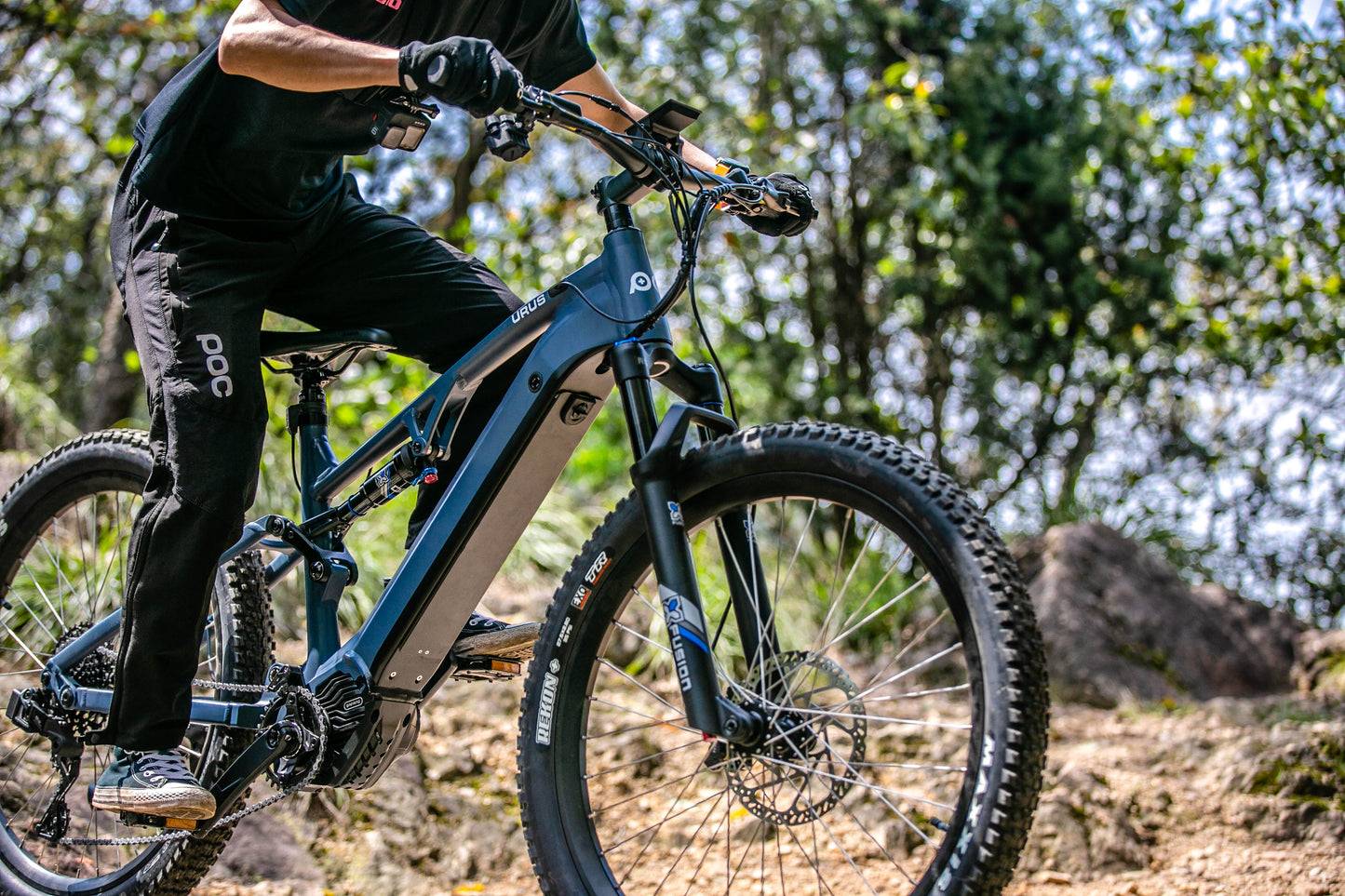 EUNORAU URUS 500W mid drive ebike with full suspension and torque sensor pedal assist shown on a dirt trail