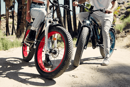 Two riders on SENADA ARCHON PLUS 1000W fat tire electric bicycles with hydraulic disc brakes, enjoying off-road adventure in a sunny landscape.