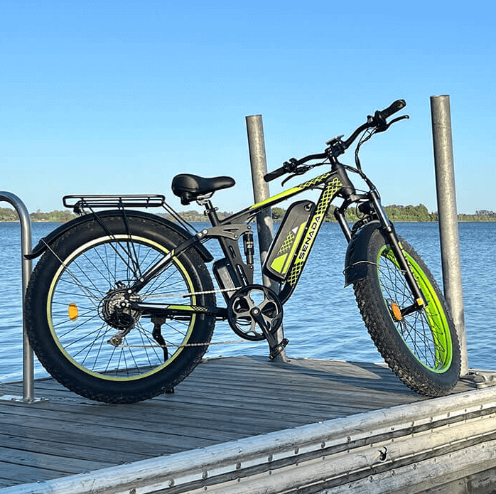 green senada viper plus 1000w rear hub motor full suspension ebike shown on a dock of a pleasant lake to demonstrate the joy of electric bicycles